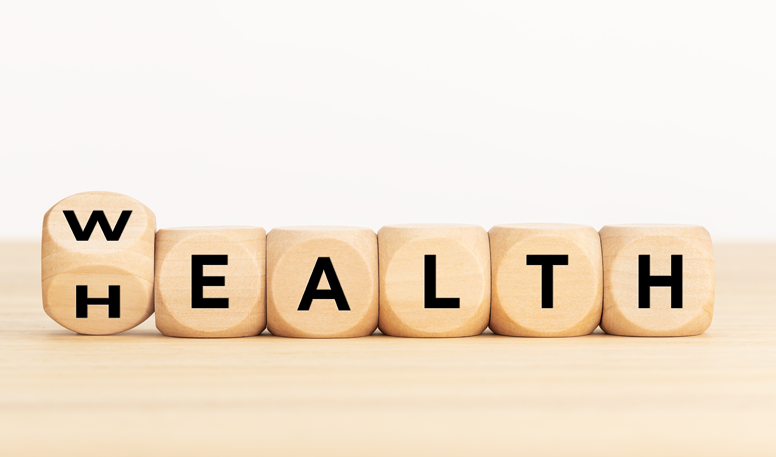 Wooden cubes with letters spelling WEALTH