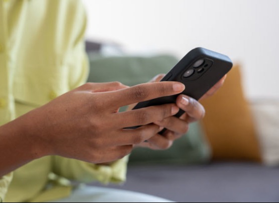 Hand using mobile phone calculator