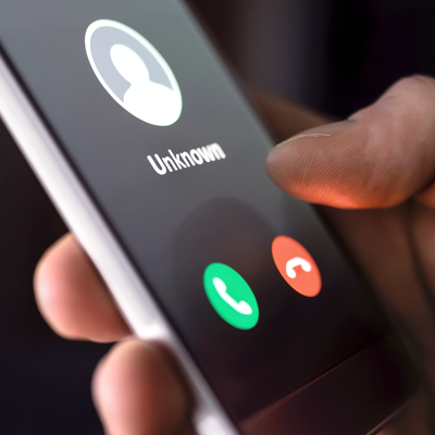 Hand holding phone with an unknown caller calling