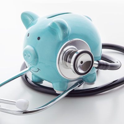 Blue piggy bank wearing a stethoscope