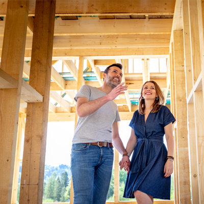 A couple touring the build site of their new house. This mortgage was provided by St. Mary's Bank.