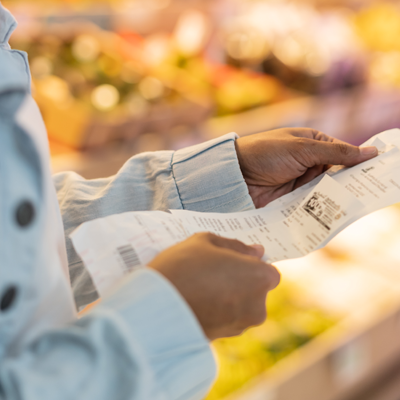 Person reviewing a shopping receipt