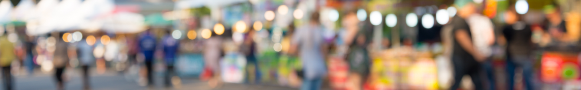 People walk through a crowded street festival
