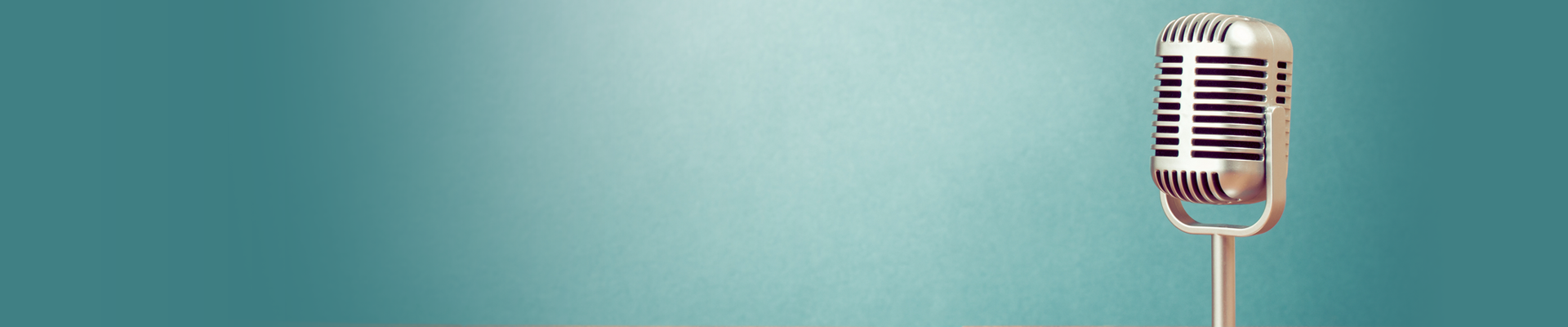 Metal microphone standing along against a blue background